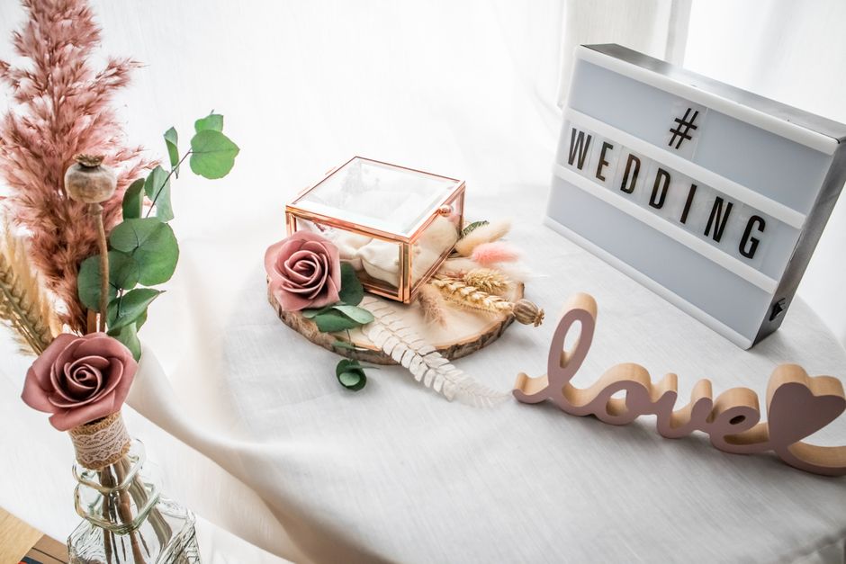 Elegant wedding decor with floral elements, lightbox sign, and love ornament, perfect for romantic celebrations.